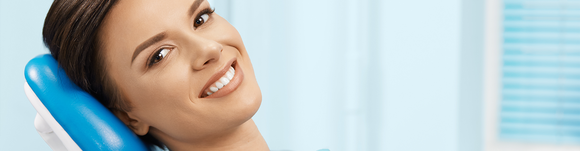 Smiling woman in dental chair.